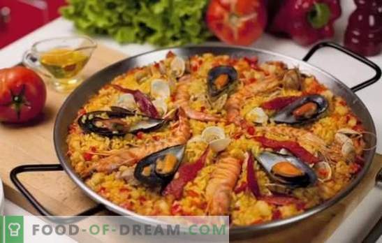 Paella met zeevruchten - plov in Spaanse stijl. Paella koken met zeevruchten en bonen, maïs, erwten, vis